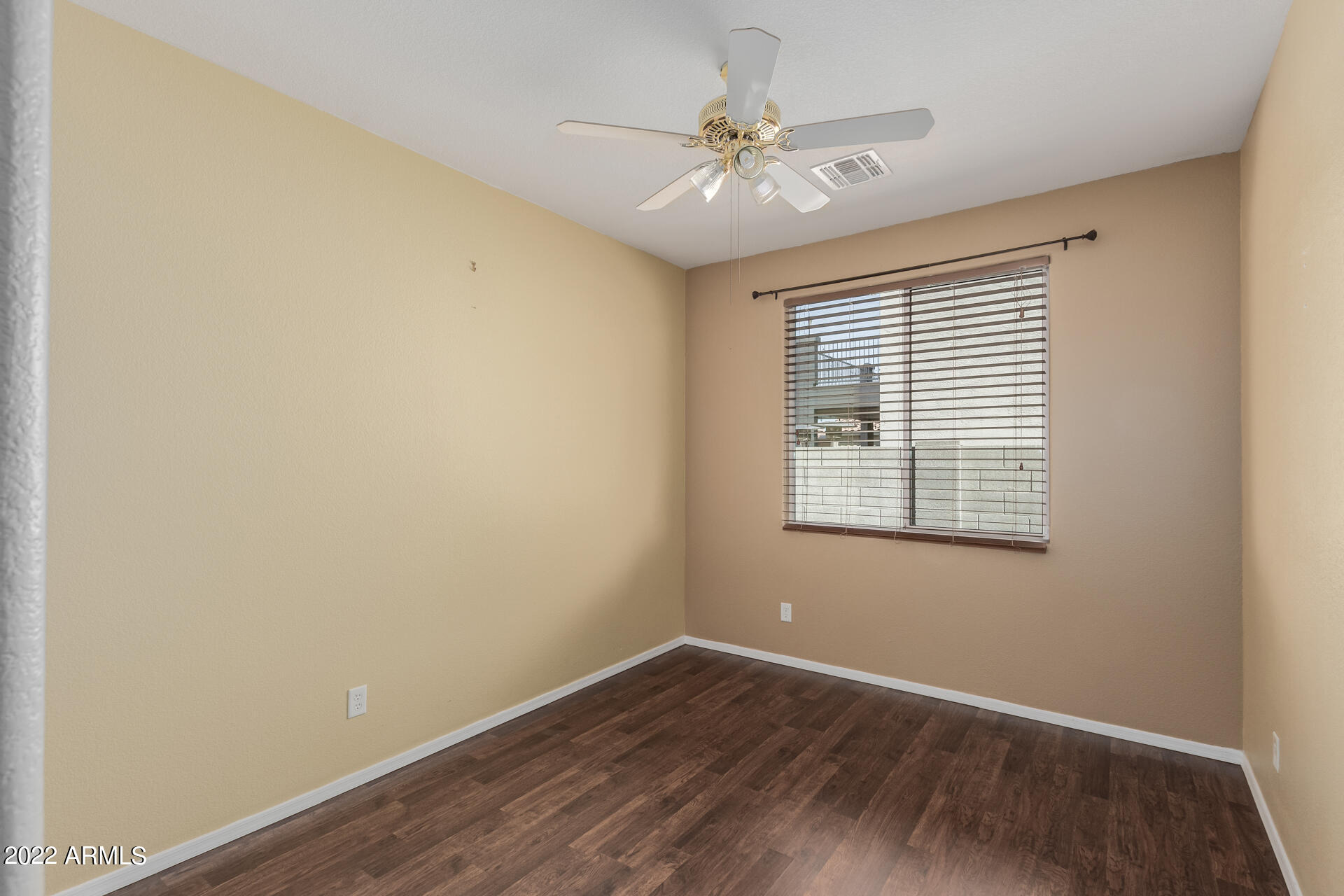 14440 West Redfield Road Surprise, AZ 85379 - Photo 34 of 36 a view of an empty room with wooden floor and a window