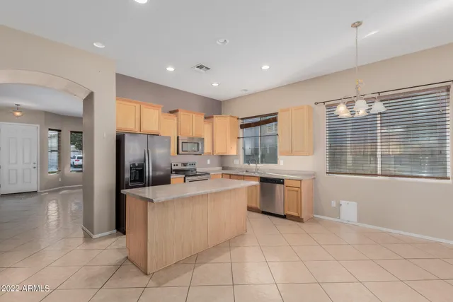 a kitchen with a refrigerator and a sink