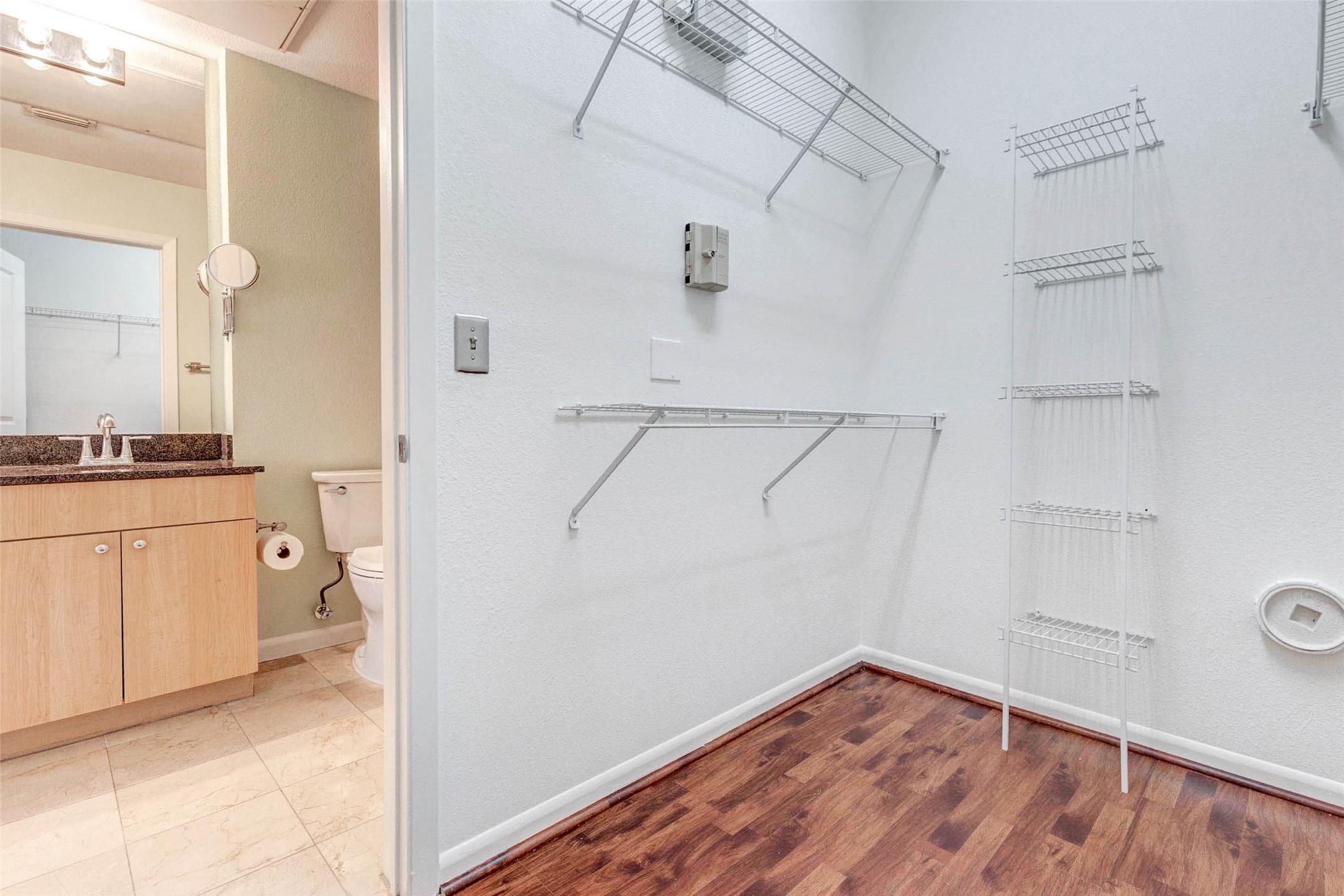 3505 Sage Road, Unit 1104 Houston, TX 77056 - Photo 21 of 31 The generous walk-in closet provides abundant storage space with multiple shelving levels designed to keep clothing, shoes, and accessories neatly organized. The open layout makes it easy to customize the space to fit your storage needs while maintaining a clean and efficient design. Located just off the primary bedroom and bathroom, this closet completes the comfortable suite layout and offers practical everyday convenience.