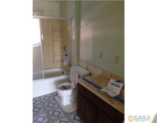 71 Pleasant Valley Road Old Bridge, NJ 08857 - Photo 4 of 4 a bathroom with a granite countertop bathtub shower sink and toilet