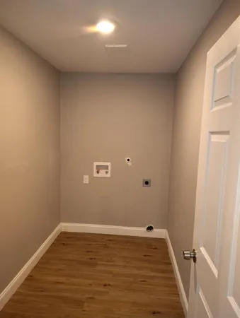 a view of a room with wooden floor