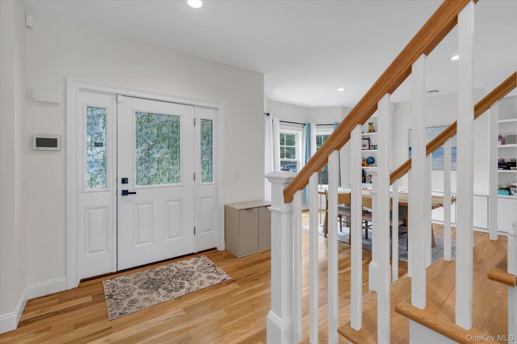 135 Elizabeth Way Ridge, NY 11961 - Photo 2 of 24 a view of staircase with wooden floor and stairs