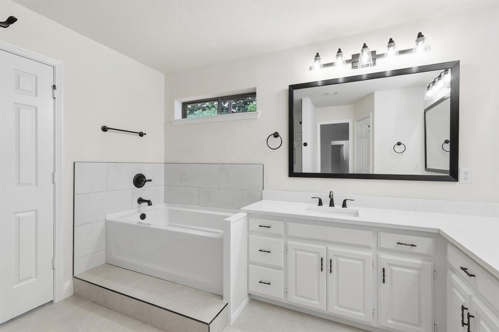 19 Timbergreen Circle Denton, TX 76205 - Photo 20 of 40 a bathroom with a double vanity sink mirror and bathtub