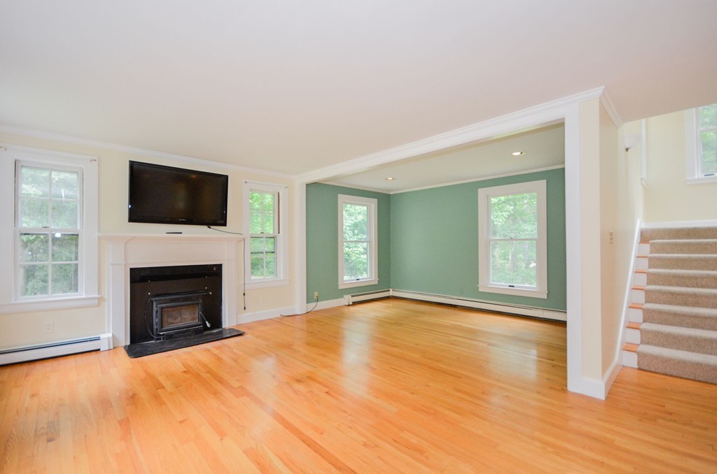 544 Point Road Marion, MA 02738 - Photo 8 of 25 a view of empty room with fireplace and wooden floor