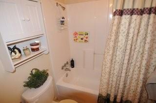 2636 Rountree Drive Abilene, TX 79601 - Photo 3 of 14 Bathroom with toilet and shower / tub combo with curtain