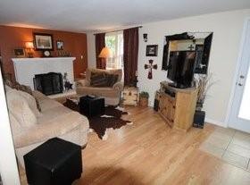 2636 Rountree Drive Abilene, TX 79601 - Photo 10 of 14 Living area with a fireplace with raised hearth and light wood-style flooring