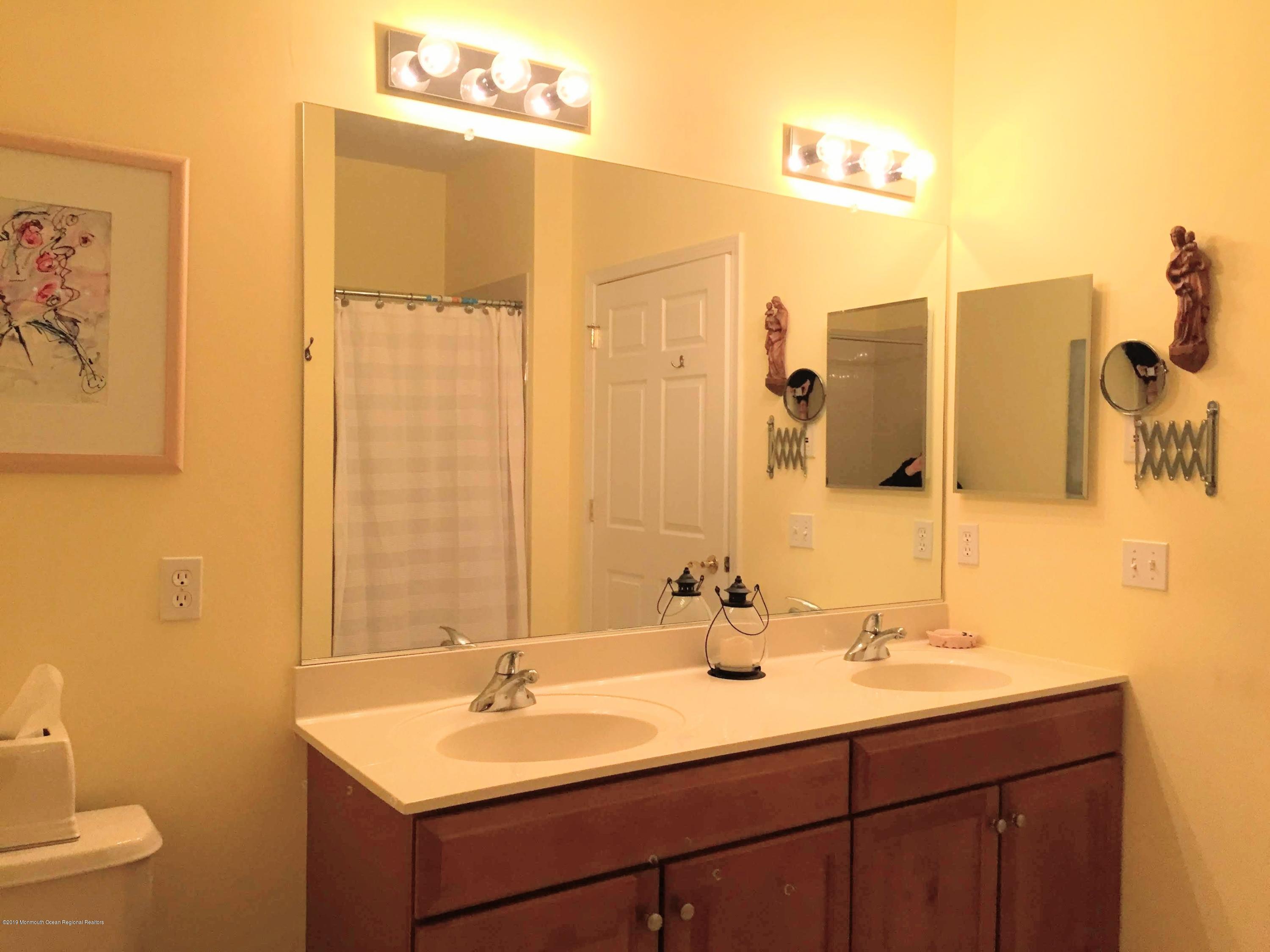 540 Cranbury Road, Unit 419 East Brunswick, NJ 08816 - Photo 22 of 42 a bathroom with a double vanity sink and a mirror