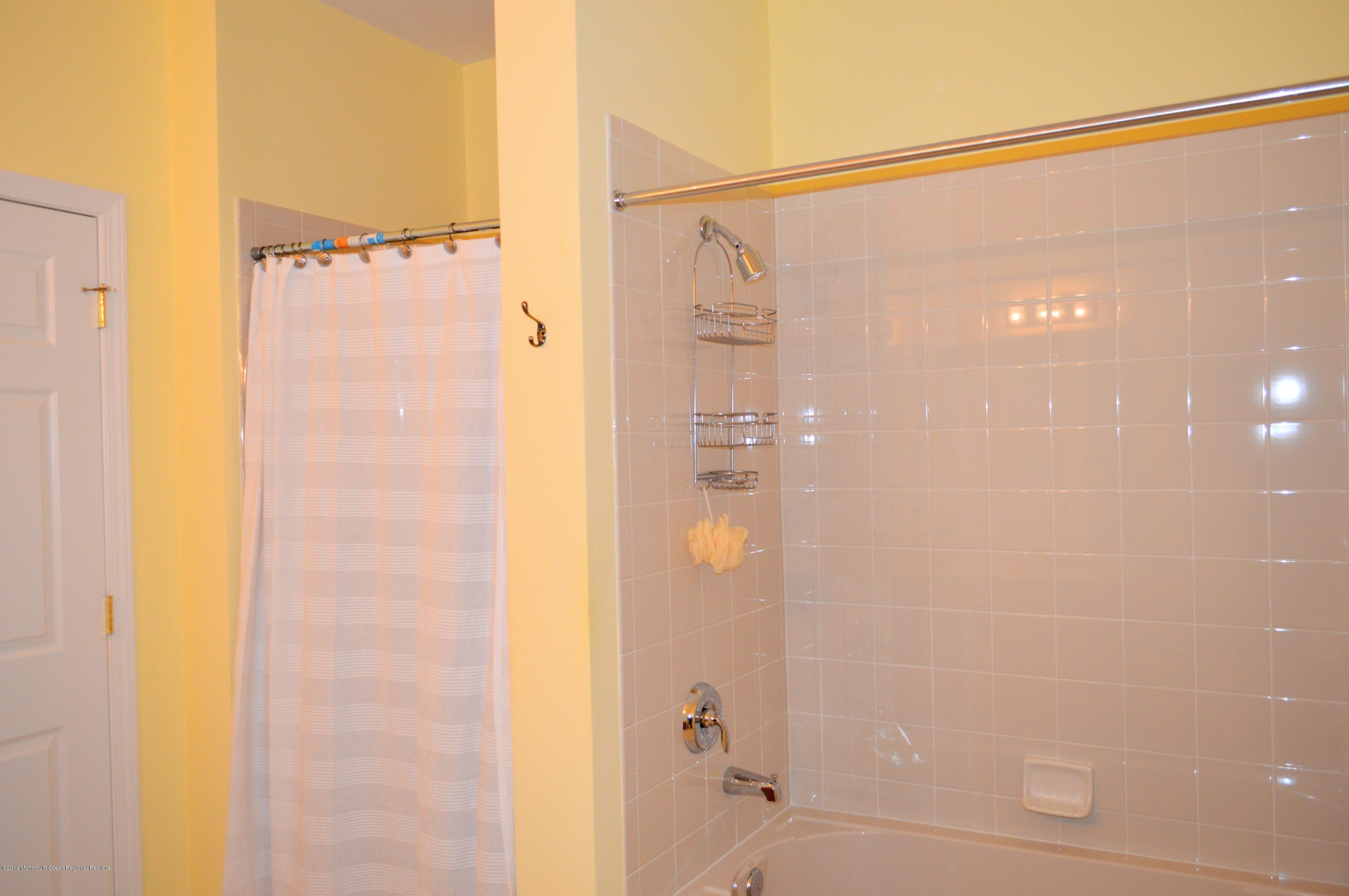 540 Cranbury Road, Unit 419 East Brunswick, NJ 08816 - Photo 23 of 42 a bathroom with a shower and a glass door