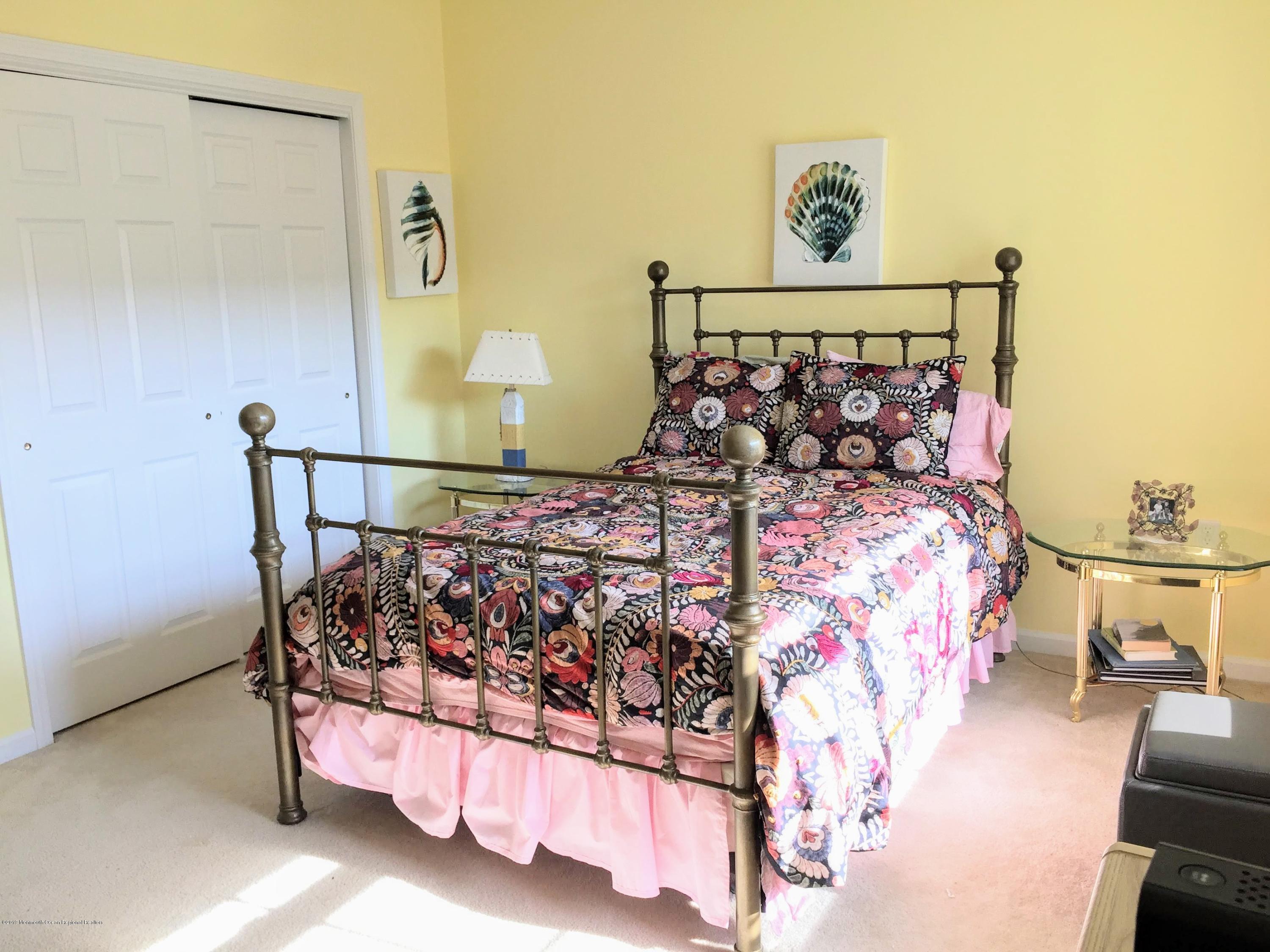 540 Cranbury Road, Unit 419 East Brunswick, NJ 08816 - Photo 24 of 42 a bed sitting in a bedroom next to a lamp