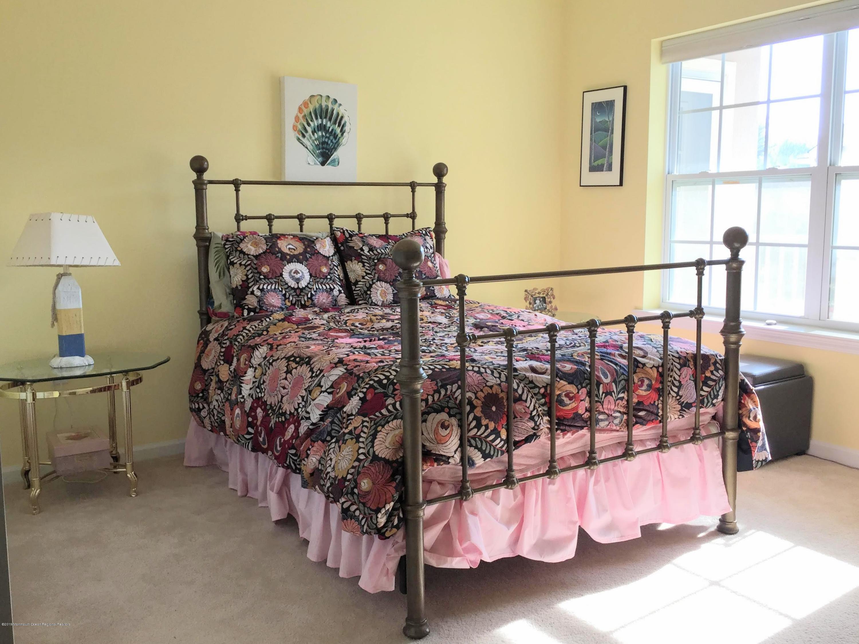 540 Cranbury Road, Unit 419 East Brunswick, NJ 08816 - Photo 25 of 42 a bed room with a bed and a night stand