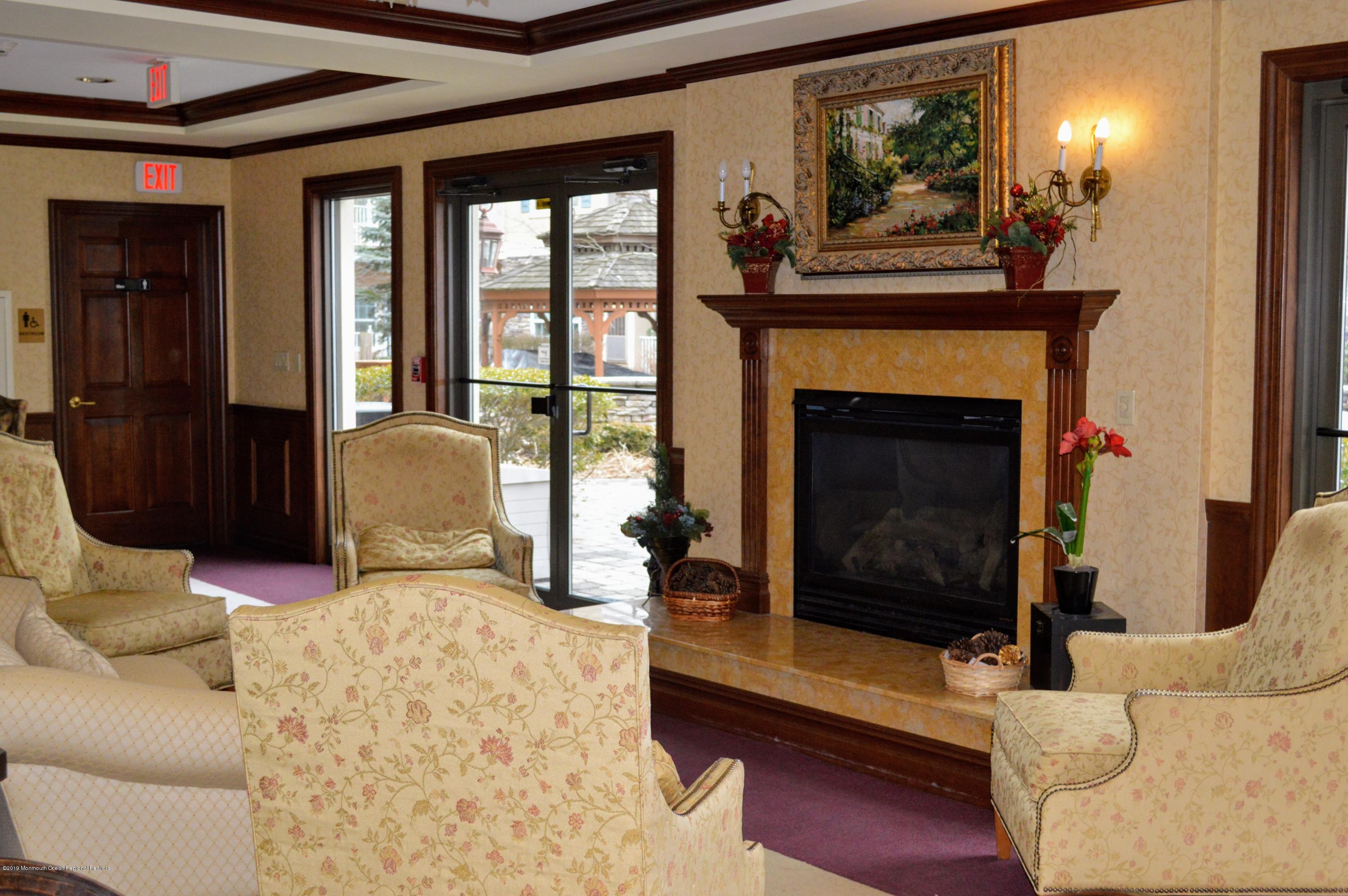 540 Cranbury Road, Unit 419 East Brunswick, NJ 08816 - Photo 26 of 42 a living room with furniture and a fireplace
