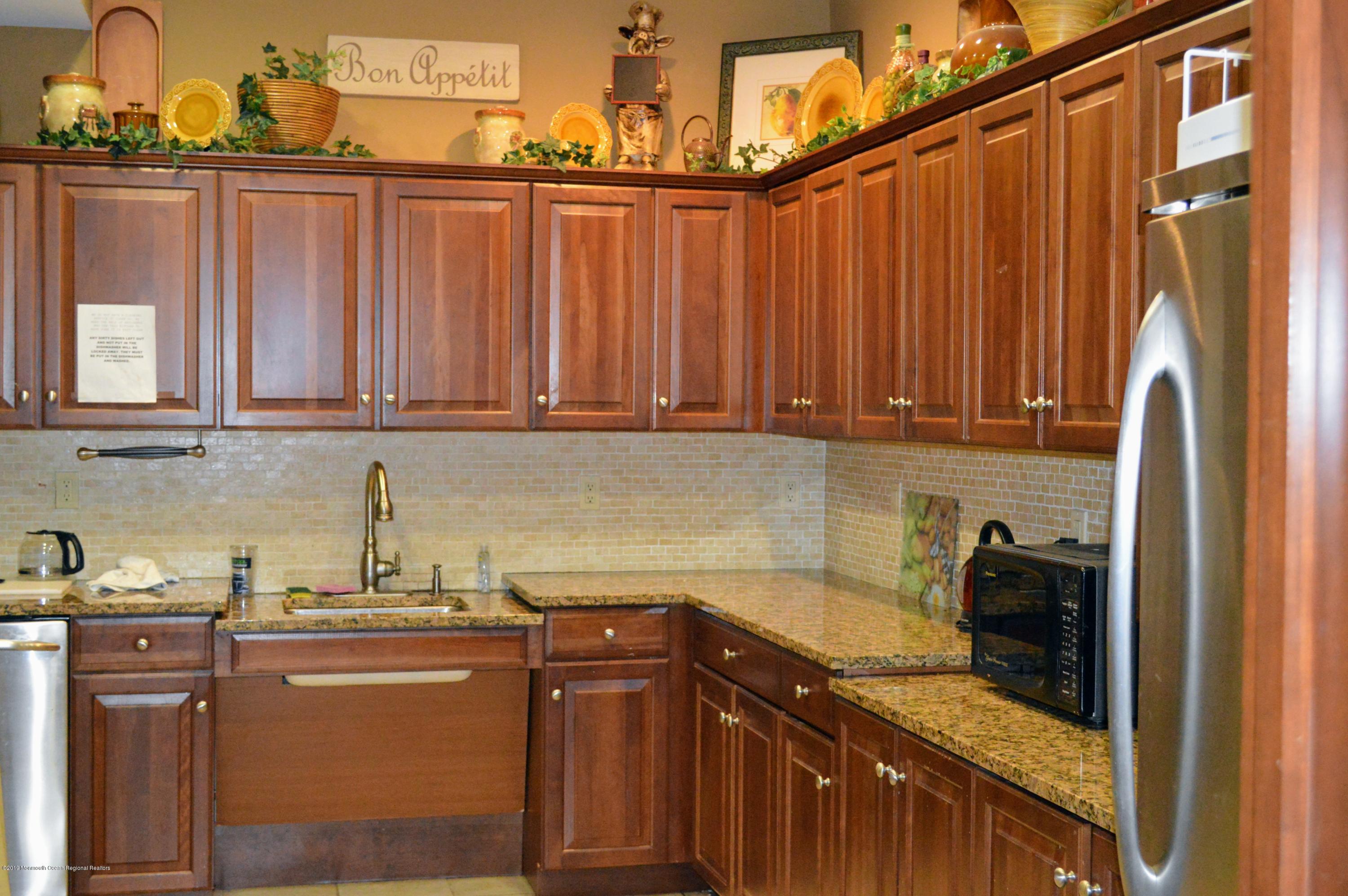 540 Cranbury Road, Unit 419 East Brunswick, NJ 08816 - Photo 29 of 42 a kitchen with stainless steel appliances granite countertop a refrigerator and a sink