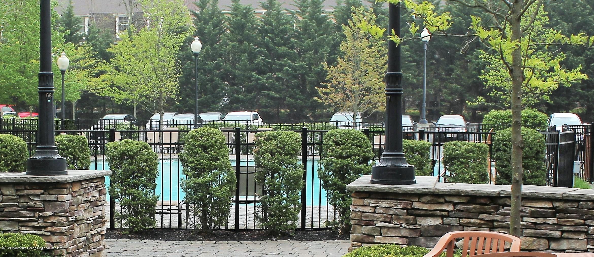 540 Cranbury Road, Unit 419 East Brunswick, NJ 08816 - Photo 37 of 42 a backyard of a house with lots of green space and fountain