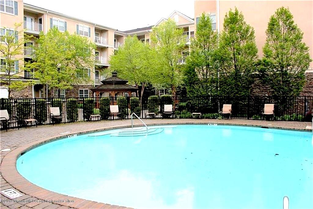 540 Cranbury Road, Unit 419 East Brunswick, NJ 08816 - Photo 38 of 42 a swimming pool with outdoor seating and yard
