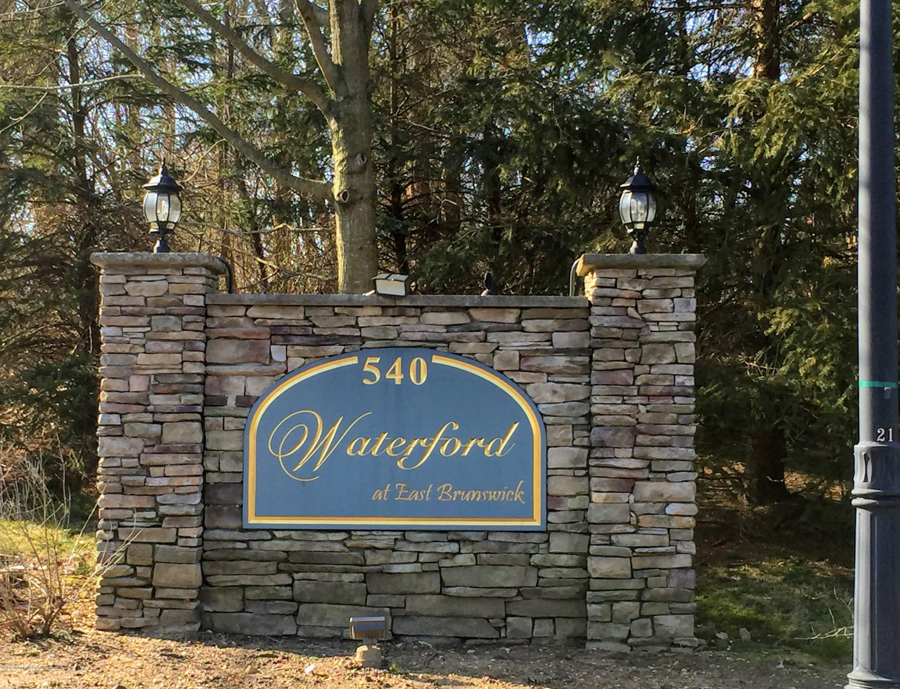 540 Cranbury Road, Unit 419 East Brunswick, NJ 08816 - Photo 41 of 42 a sign that is sitting on a brick wall