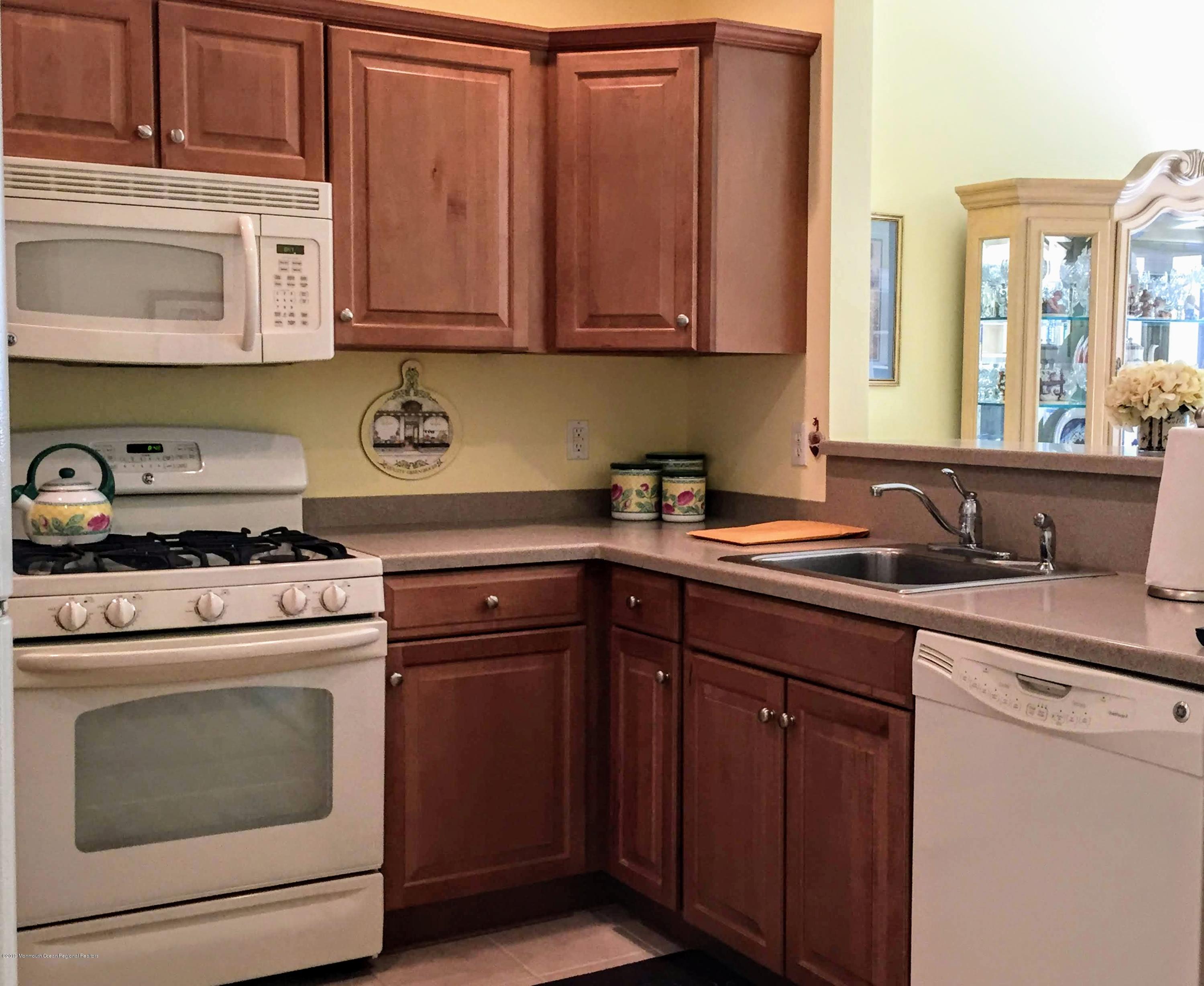 540 Cranbury Road, Unit 419 East Brunswick, NJ 08816 - Photo 5 of 42 a kitchen with stainless steel appliances granite countertop a sink stove and cabinets