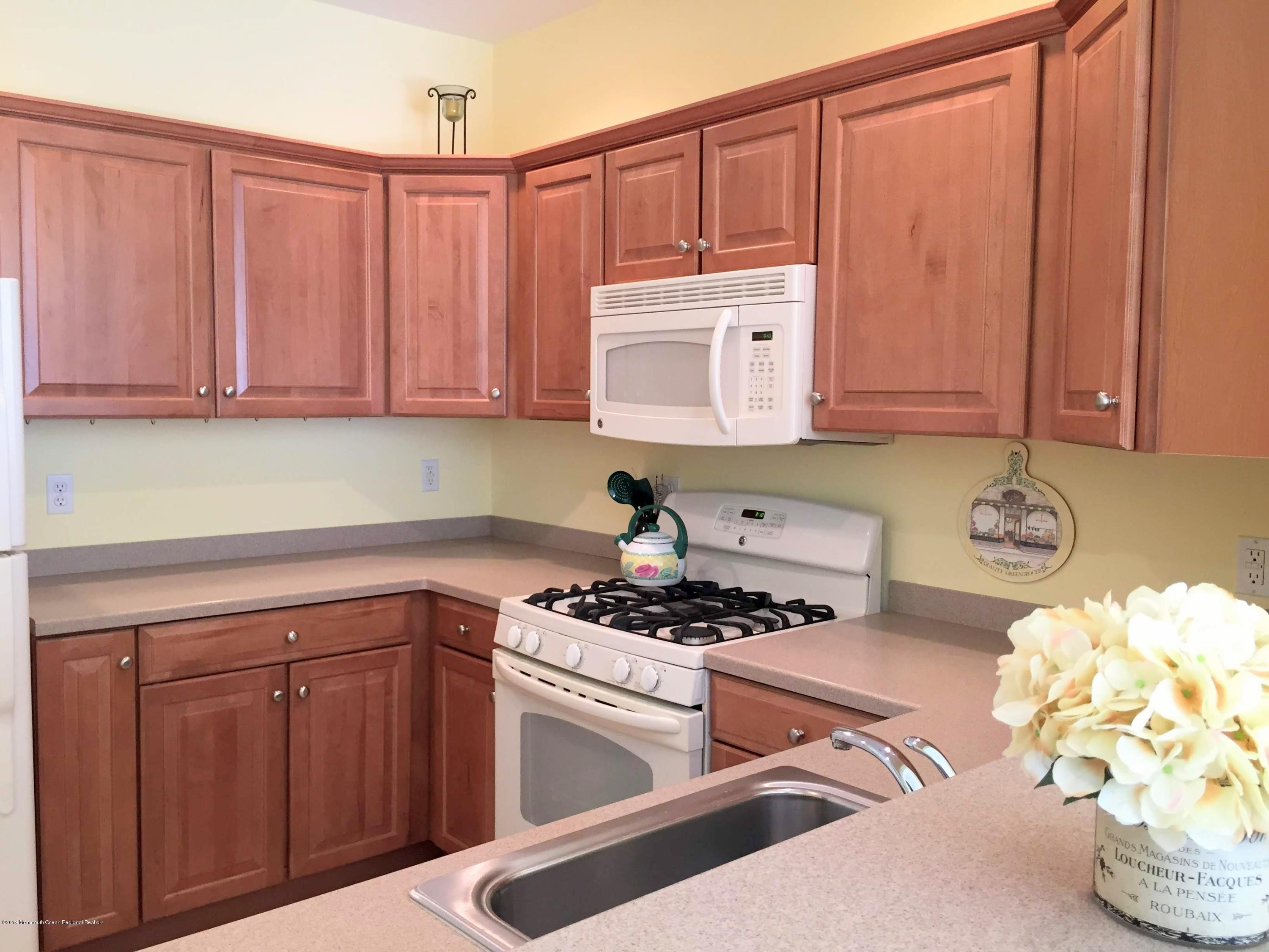 540 Cranbury Road, Unit 419 East Brunswick, NJ 08816 - Photo 6 of 42 a kitchen with stainless steel appliances granite countertop a sink stove and cabinets