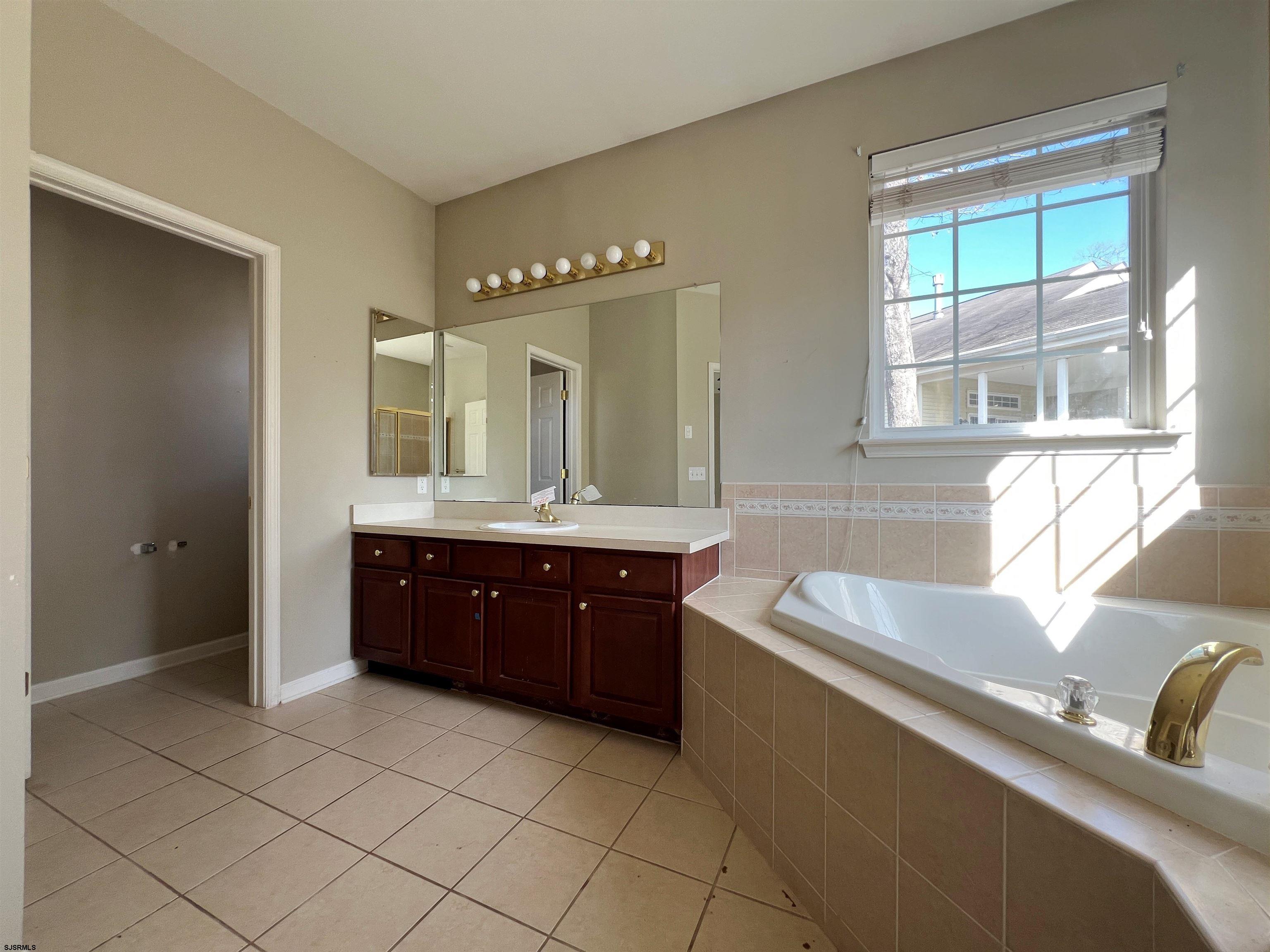8 Manchester Street Galloway Township, NJ 08205 - Photo 22 of 31 a spacious bathroom with a tub sink and mirror
