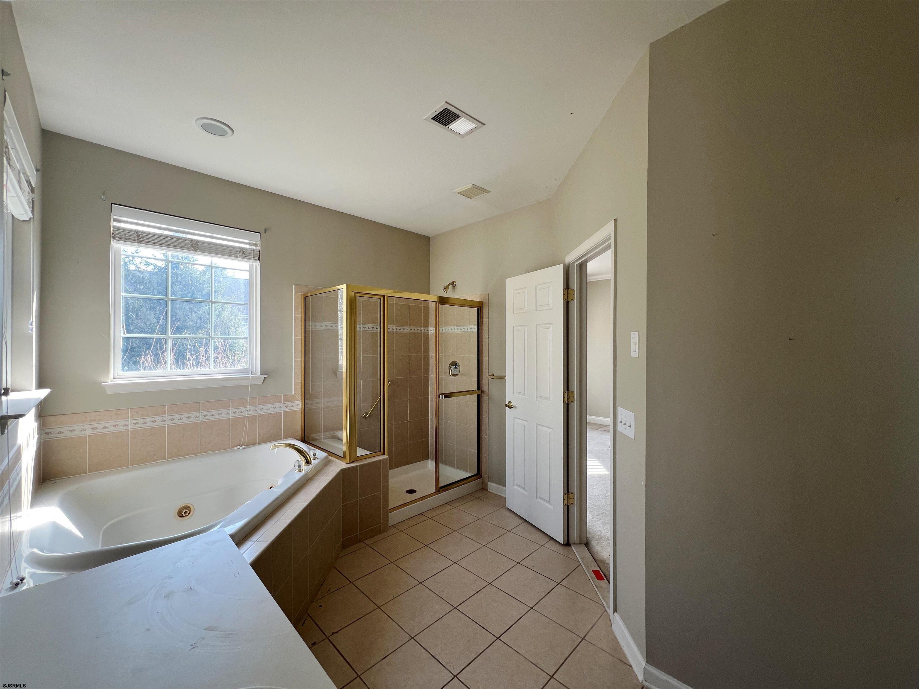 8 Manchester Street Galloway Township, NJ 08205 - Photo 23 of 31 a spacious bathroom with a tub a mirror and a shower