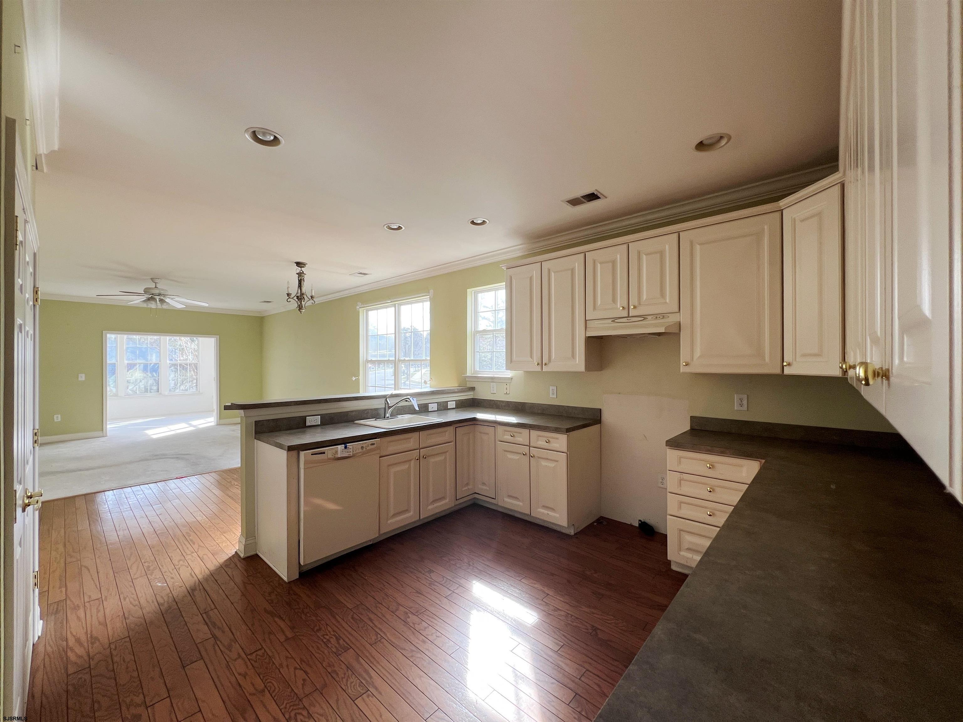 8 Manchester Street Galloway Township, NJ 08205 - Photo 9 of 31 a large kitchen with granite countertop a stove and a wooden floors