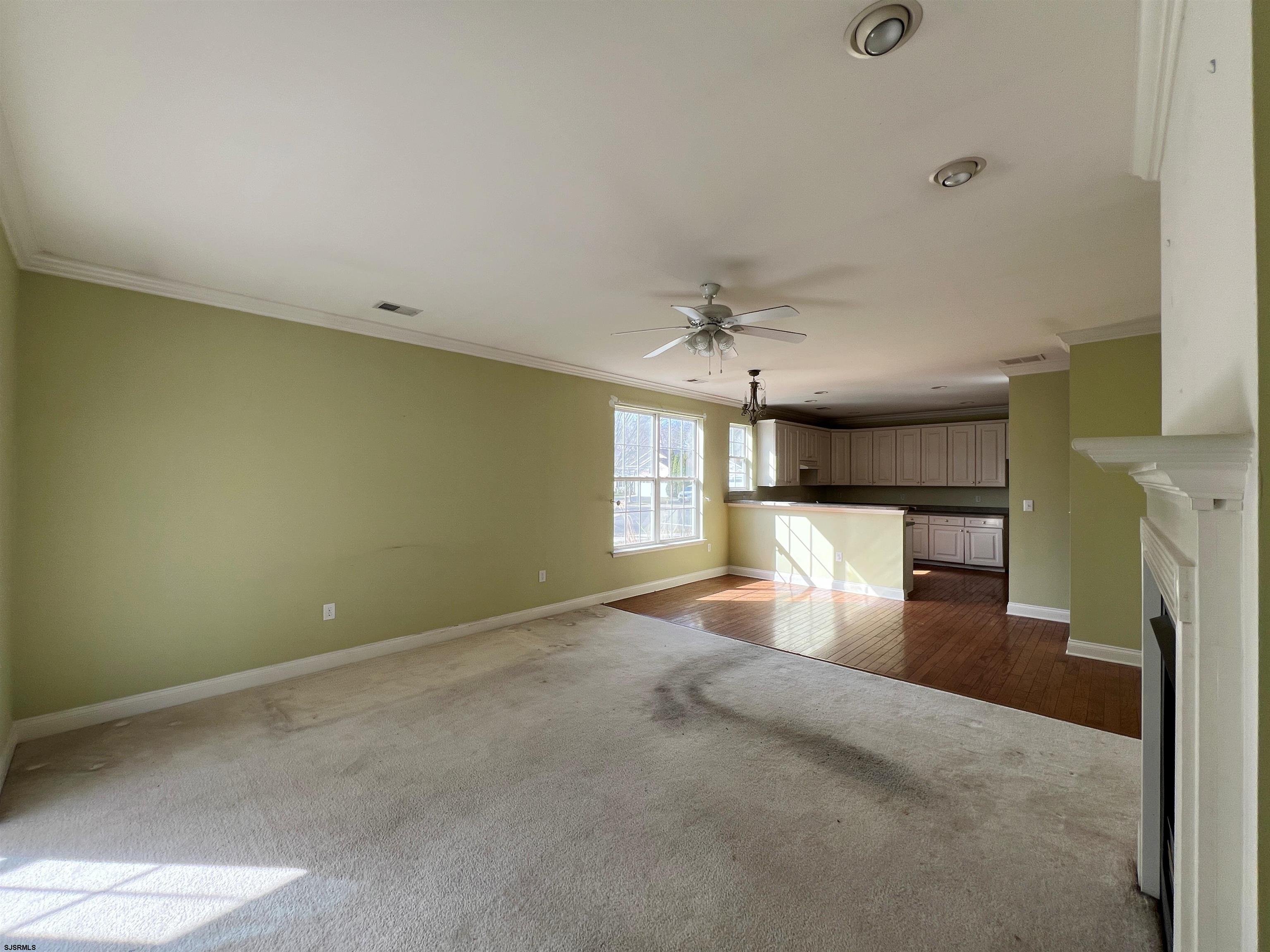 8 Manchester Street Galloway Township, NJ 08205 - Photo 10 of 31 an empty room with fireplace and windows