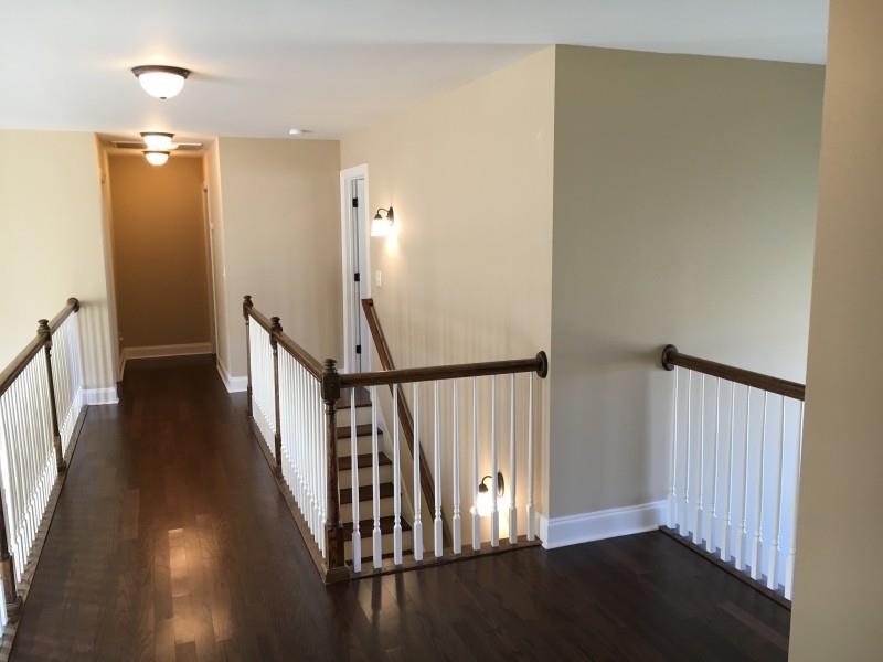 2012 Lincoln Road Spring Hill, TN 37174 - Photo 18 of 25 a view of a hallway with wooden floor and staircase