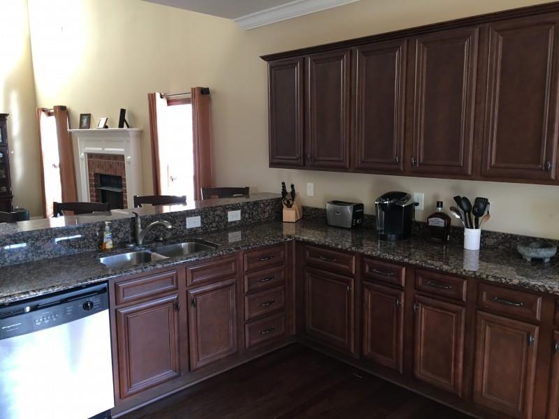 2012 Lincoln Road Spring Hill, TN 37174 - Photo 8 of 25 a kitchen with granite countertop wooden cabinets a sink and dishwasher