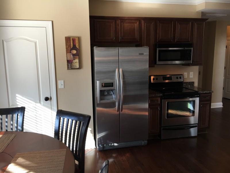 2012 Lincoln Road Spring Hill, TN 37174 - Photo 9 of 25 a kitchen with granite countertop stainless steel appliances and wooden cabinets
