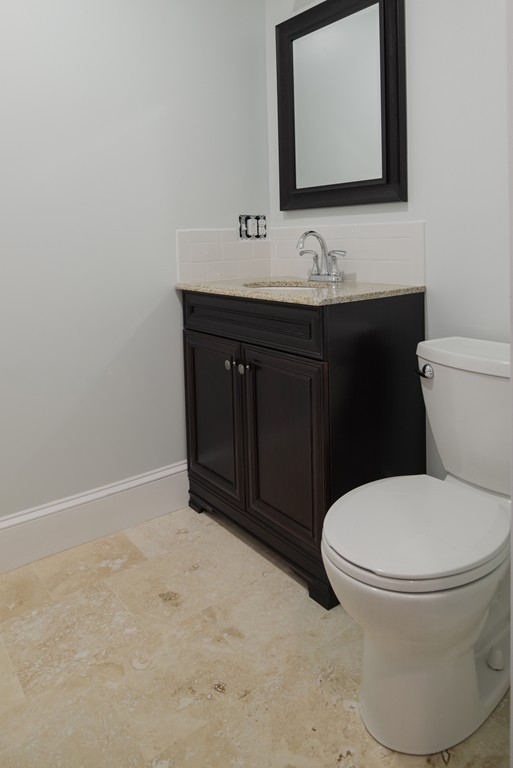 22 Marble Road Gloucester, MA 01930 - Photo 20 of 25 a bathroom with a toilet sink and mirror