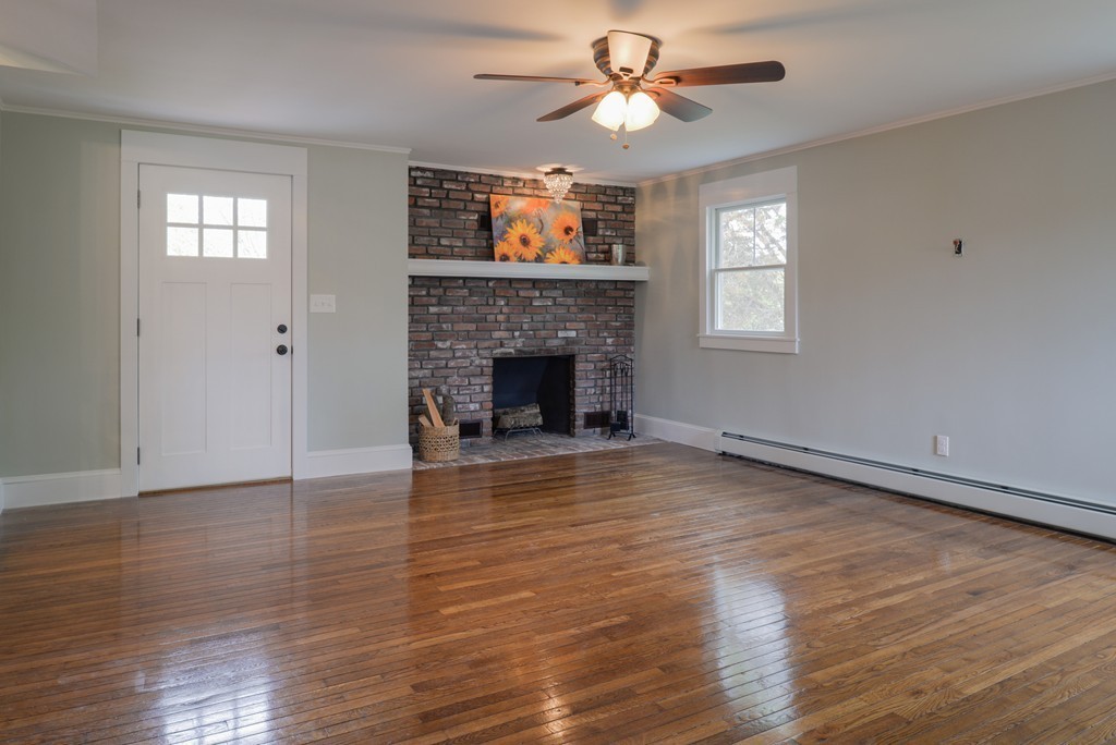 22 Marble Road Gloucester, MA 01930 - Photo 6 of 25 an empty room with wooden floor fireplace and windows