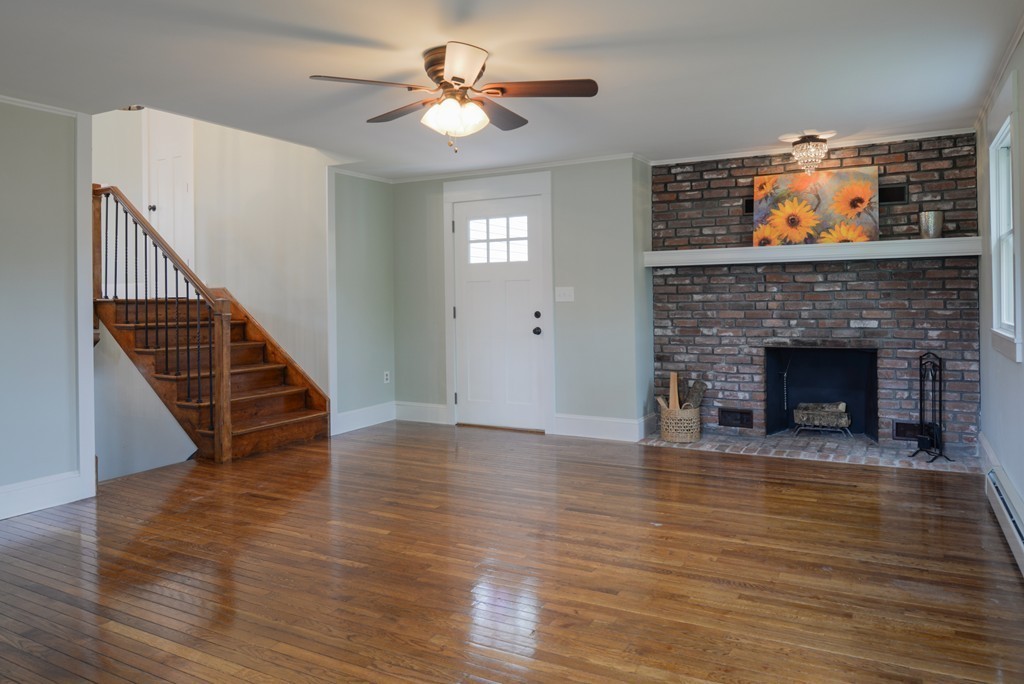 22 Marble Road Gloucester, MA 01930 - Photo 7 of 25 a view of an empty room with wooden floor fireplace and a window