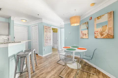a view of a dining room with furniture and wooden floor