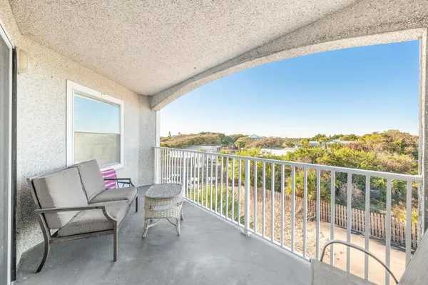 a balcony with furniture and wooden floor