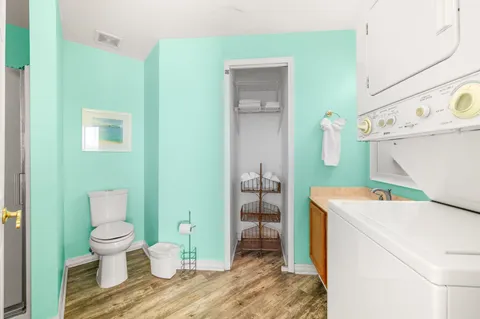 a bathroom with a sink toilet and shower