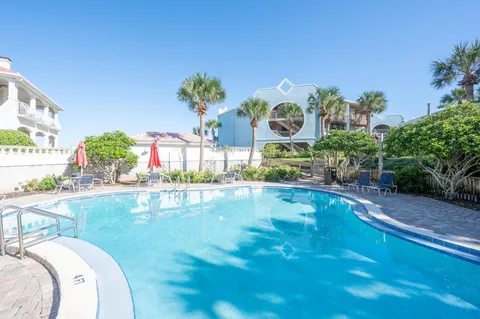 a swimming pool with trees in the background