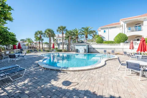 a view of a swimming pool with outdoor seating