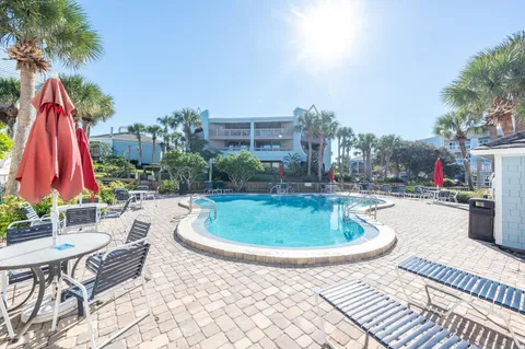 a swimming pool with outdoor seating and yard