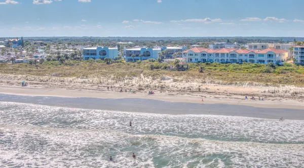 a view of a city with tall buildings and a big yard