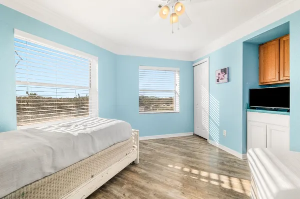 a bedroom with a large bed and a tv