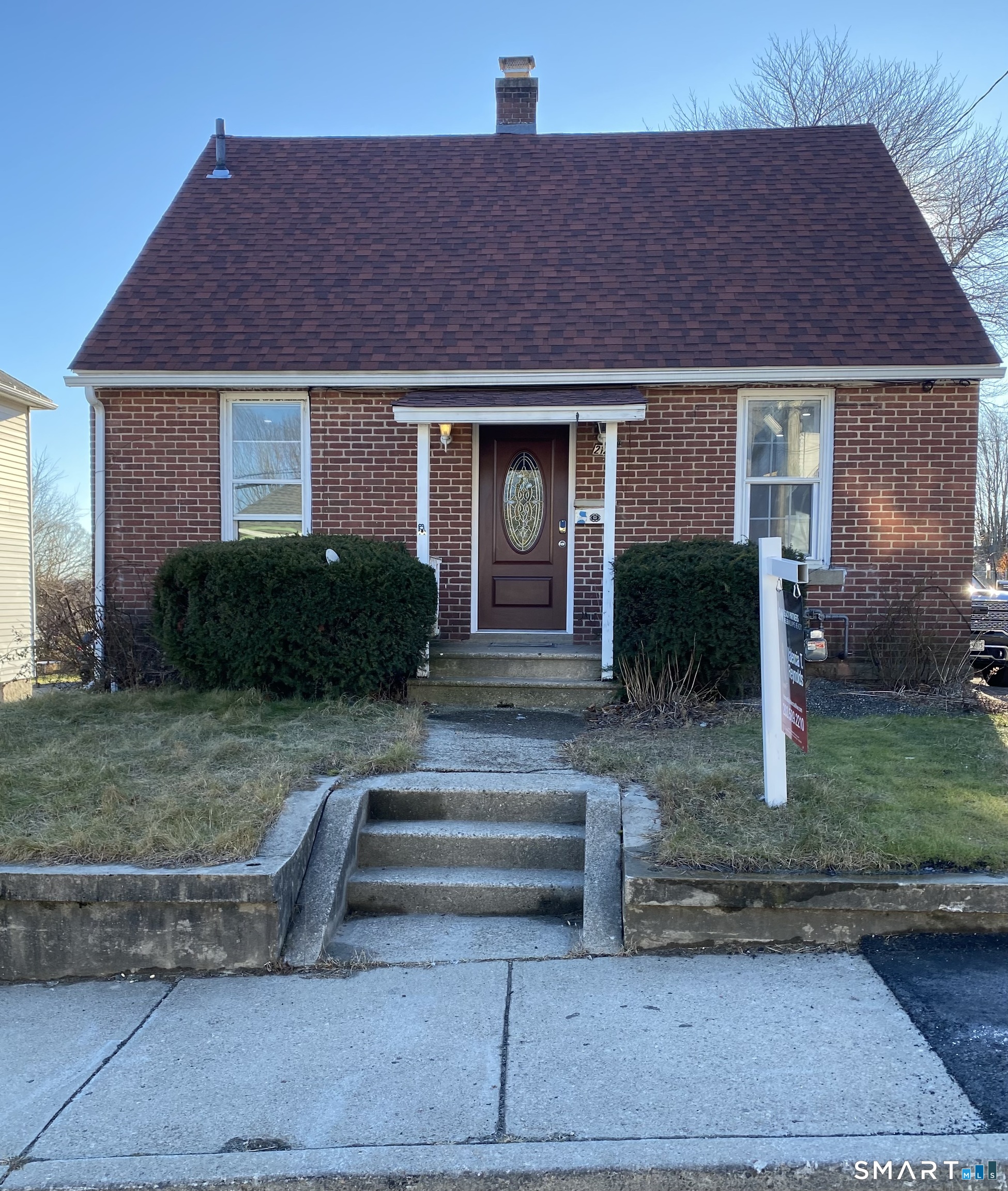a front view of a house with garden