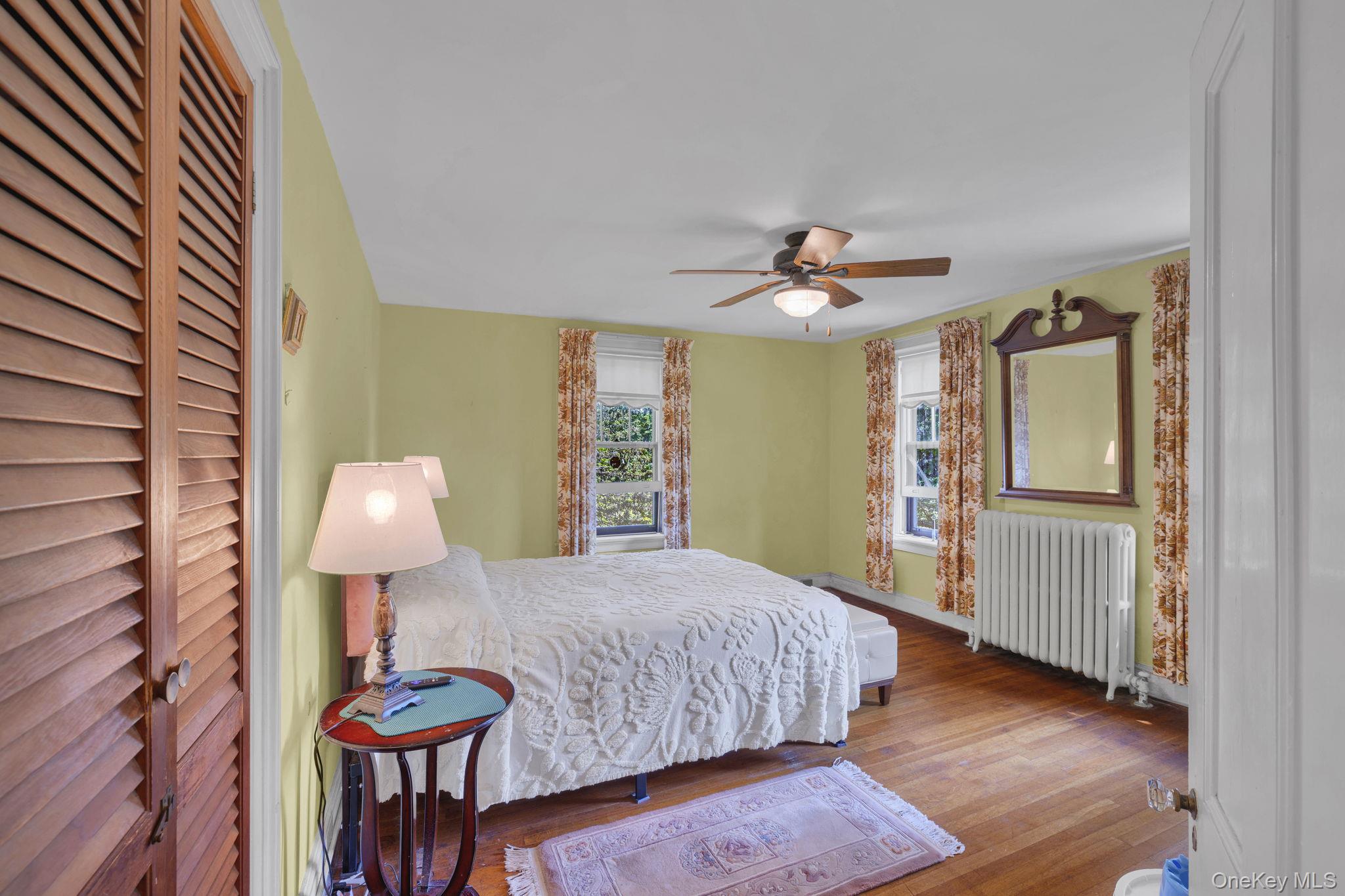 470 Little Britain Road Newburgh, NY 12550 - Photo 27 of 45 Bedroom featuring wood finished floors, radiator heating unit, and ceiling fan