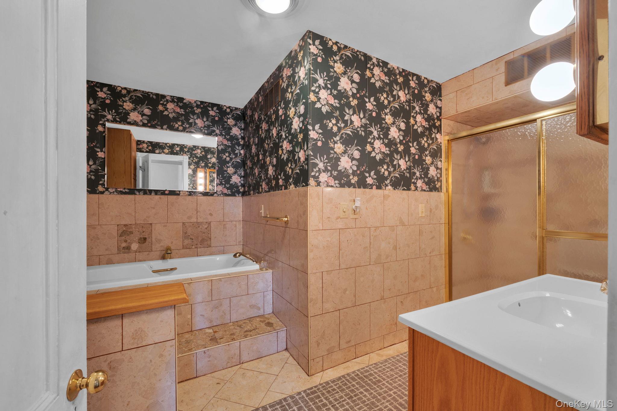 470 Little Britain Road Newburgh, NY 12550 - Photo 28 of 45 Full bath featuring tile patterned floors, tile walls, vanity, a stall shower, and a garden tub