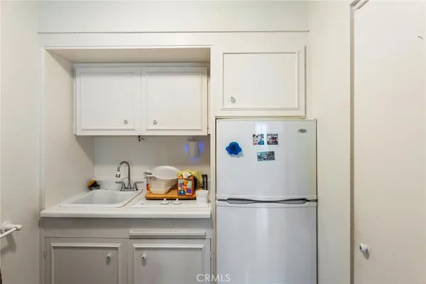 a kitchen with a refrigerator and cabinets