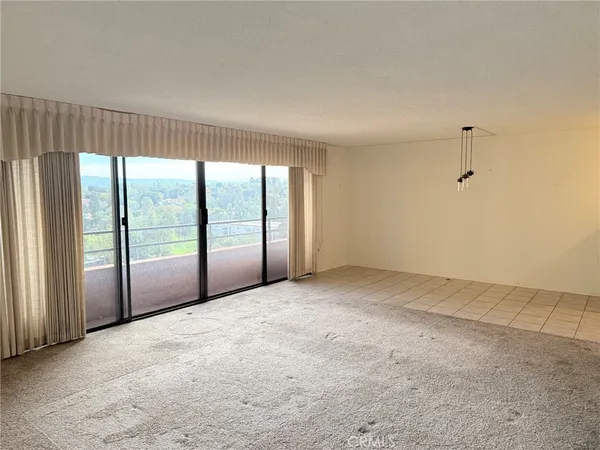 an empty room with large windows