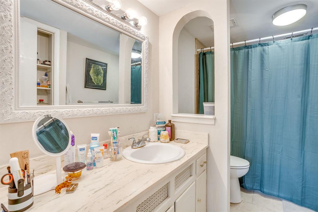4102 Ridglea Country Club Drive, Unit 1503 Fort Worth, TX 76126 - Photo 5 of 21 Bathroom vanity featuring an integrated sink, a light-toned countertop, and white cabinetry