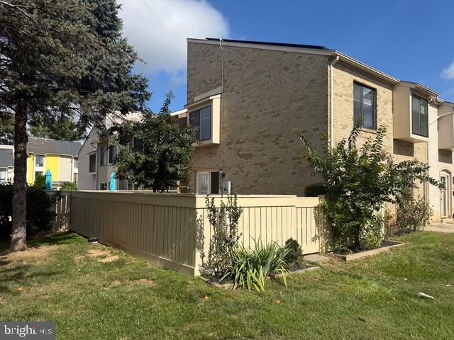 front view of a brick house with a yard