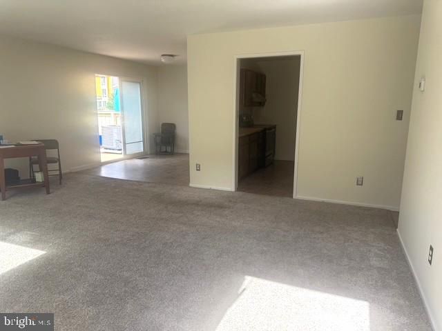 a kitchen with a sink a refrigerator and cabinets