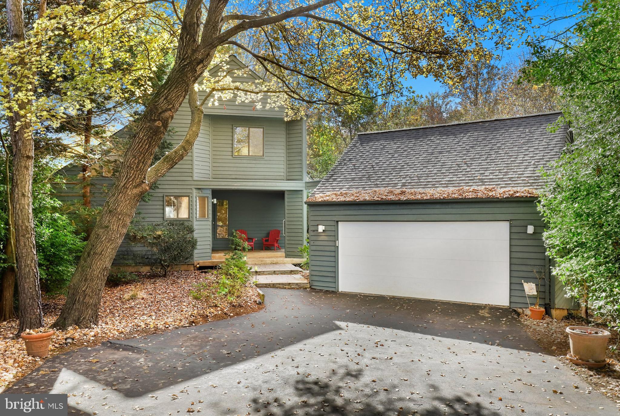 a front view of a house with a yard and a garage