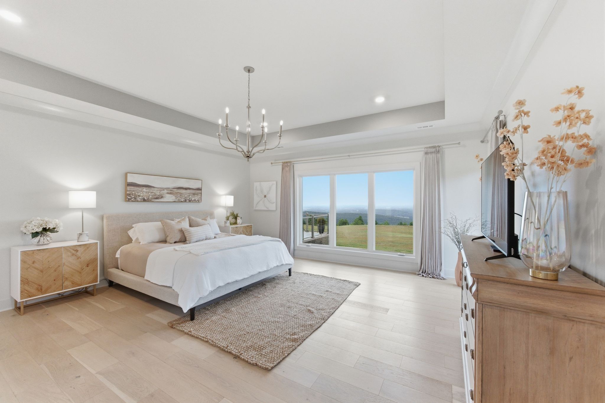 577 Box House Road Belvidere, TN 37306 - Photo 26 of 77 a spacious bedroom with a large bed and a chandelier