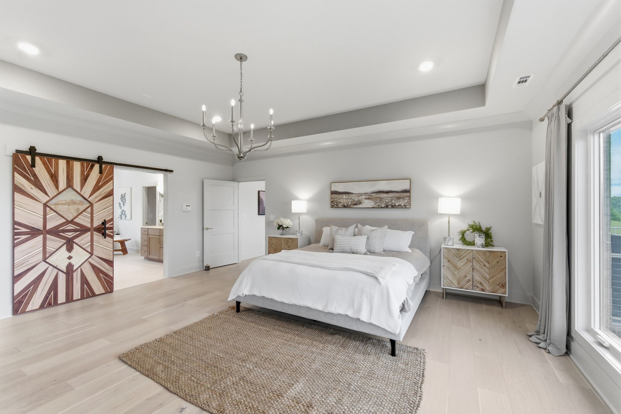 577 Box House Road Belvidere, TN 37306 - Photo 27 of 77 a spacious bedroom with a bed and a chandelier